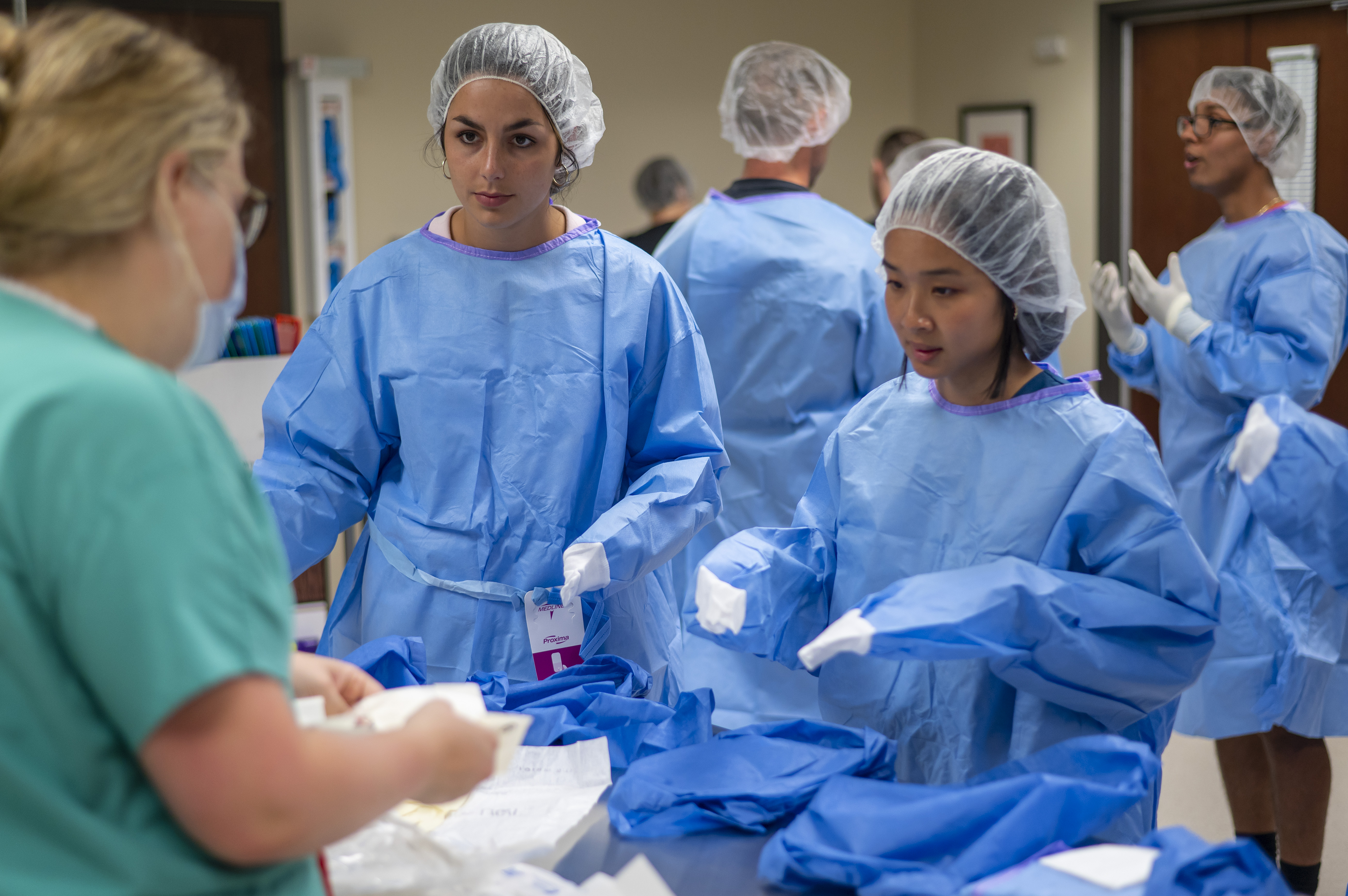 Elon Physician Assistant Students in a lab with their scrubs on